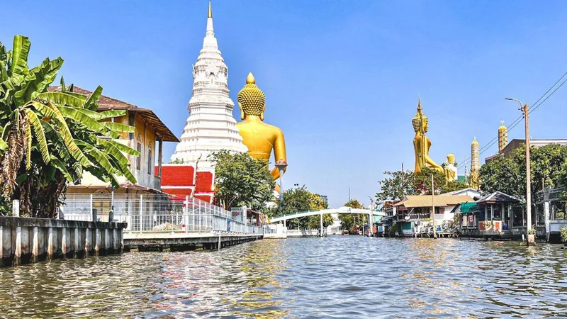 Couple on a private longtail boat cruising through narrow Bangkok canal flanked by tropical vegetation on a private boat tour bangkok